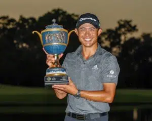 An Image of Collin Morikawa holding a cup for an Achievement in his Golf Career