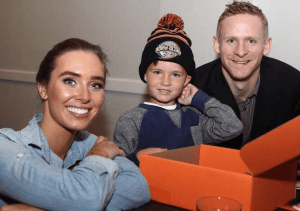 An Image of Corey Perry, his wife Blakney Perry and their son