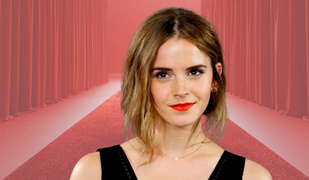 A woman posing on a red carpet with a soft smile