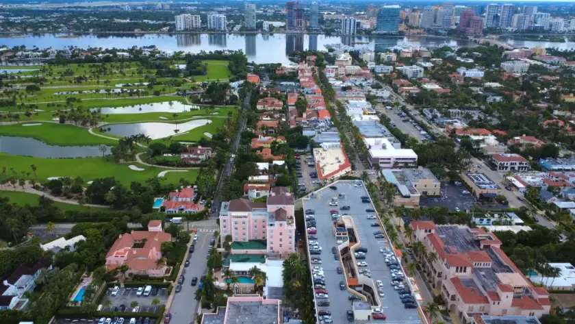 An aerial view of a Florida city showing neighborhoods, golf courses, and coastal buildings