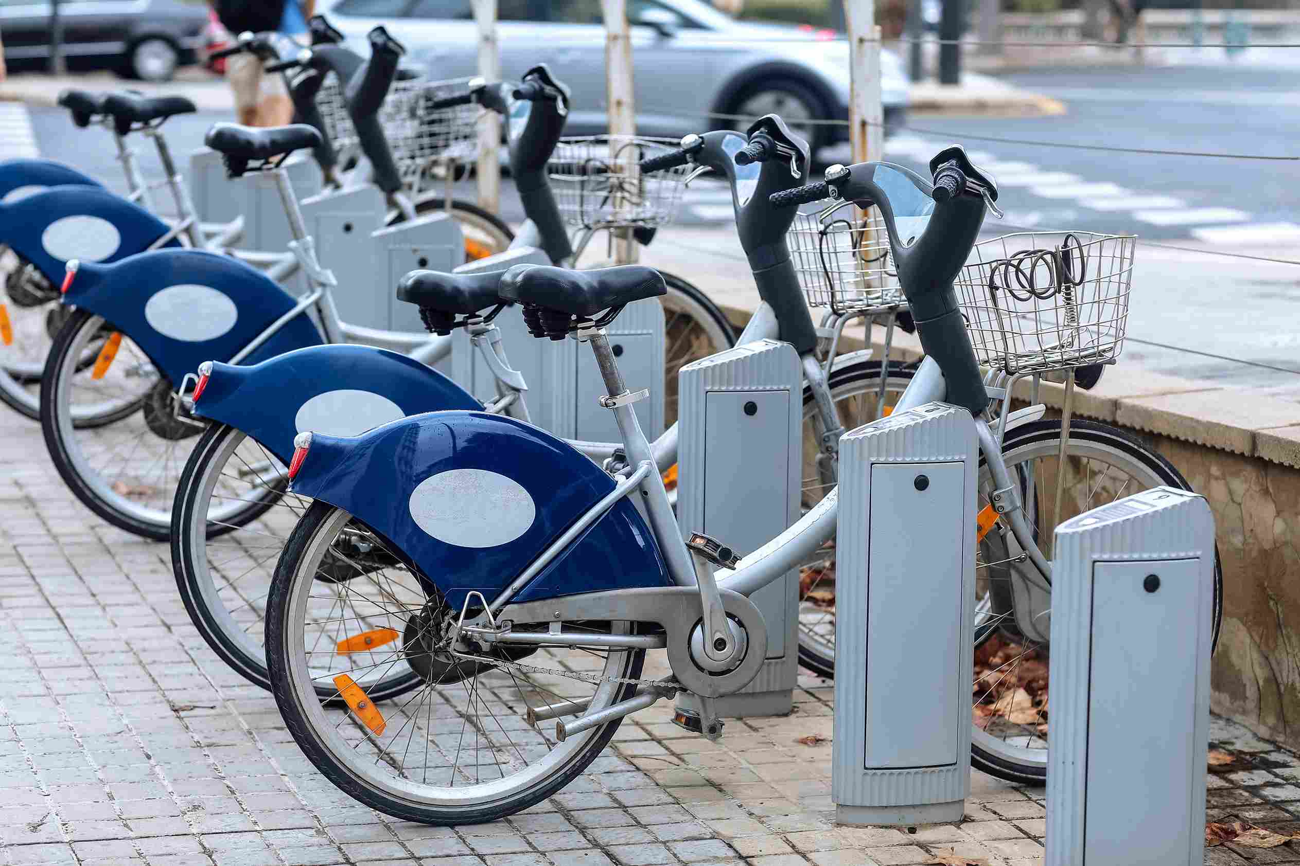 Public bike share bicycles docked along a city street