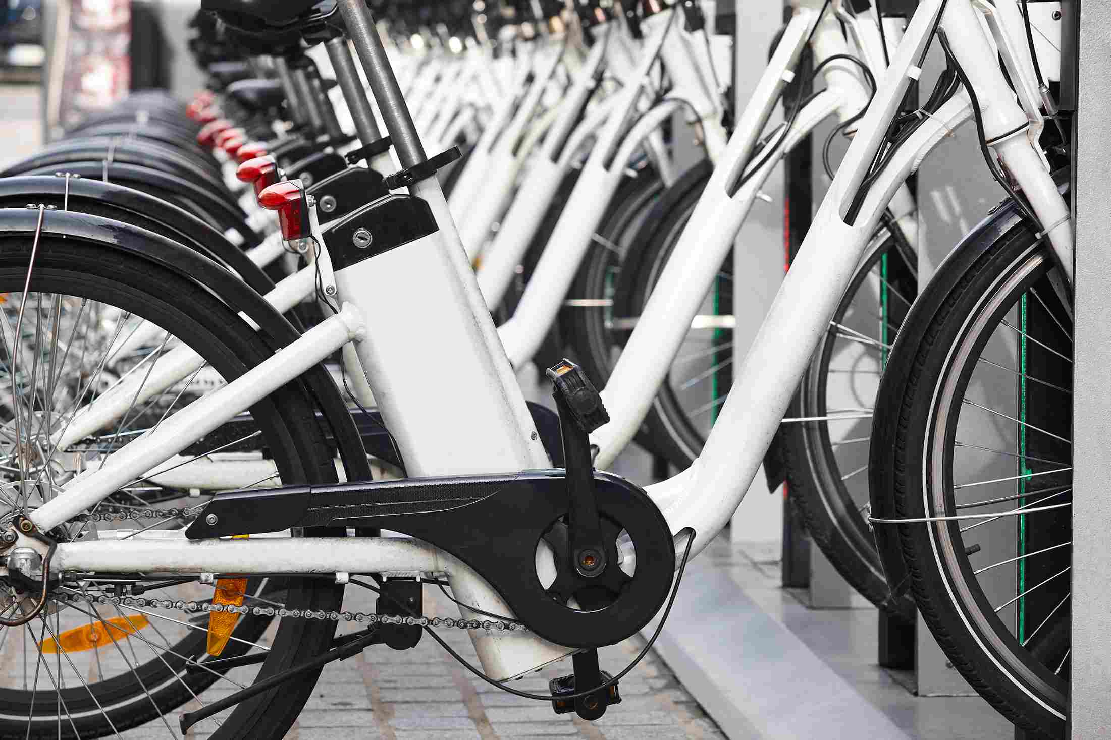 Row of electric bicycles parked in a docking station