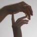 Hands touching gently in a sexual wellness article image