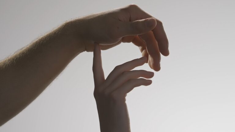 Hands touching gently in a sexual wellness article image