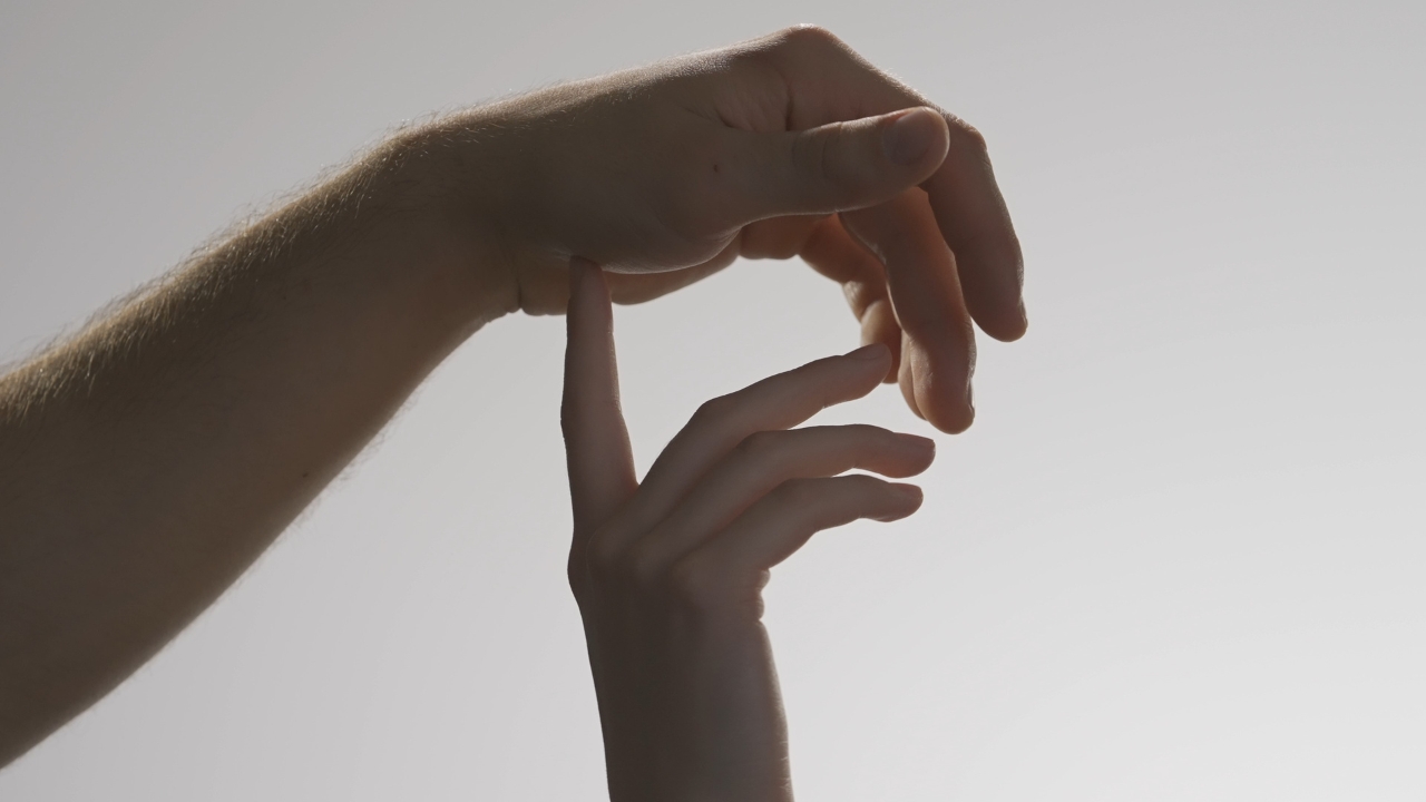 Hands touching gently in a sexual wellness article image