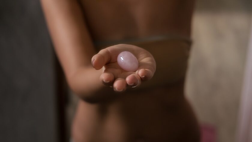 Person holding a pink sexual wellness product in their hand