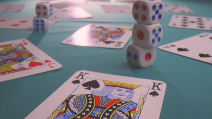 Dice and cards spread across a casino table