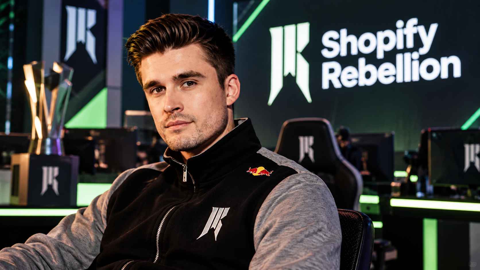 Ludwig Ahgren in an esports studio with the Shopify Rebellion logo behind him.