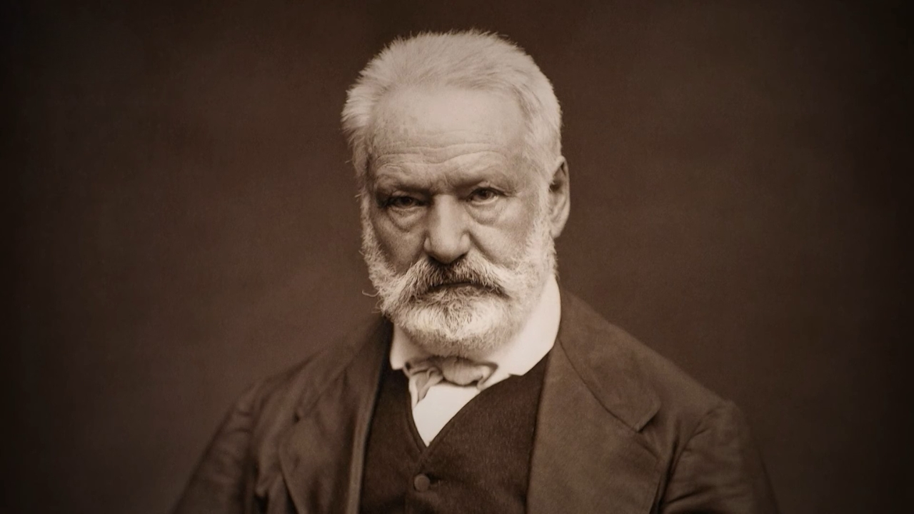 Sepia portrait of Victor Hugo in a dark suit against a plain background.