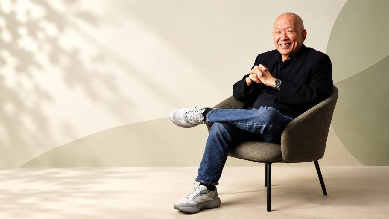 Filipino businessman Eusebio Yosi Tanco seated in a chair, smiling for a portrait.